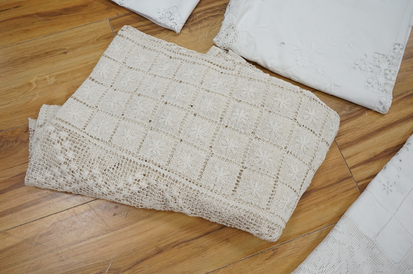 A collection of early 20th century and later crochet, cut work and drawn thread table linens and a large embroidered table cloth